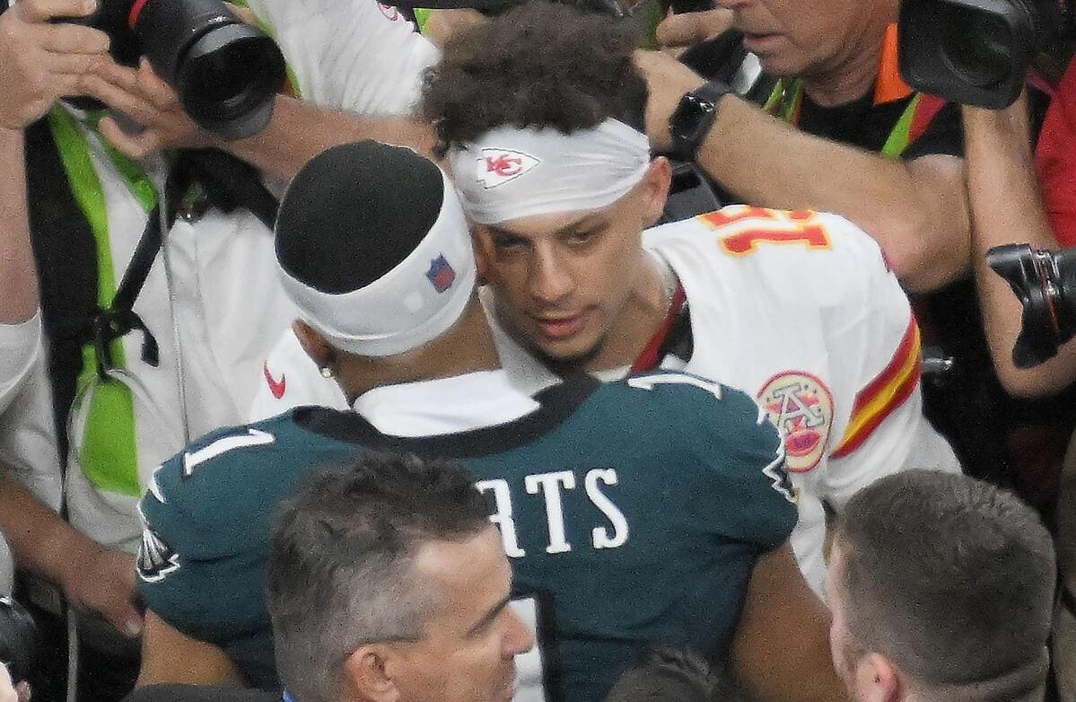 Kansas City Chiefs quarterback Patrick Mahomes talks with Philadelphia Eagles quarterback Jalen Hurts after Super Bowl LIX.