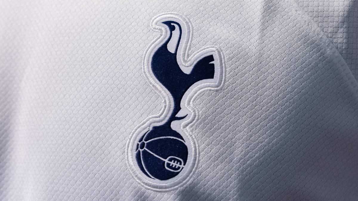 A close-up of the Tottenham kit showing the Spurs badge on the club shirt